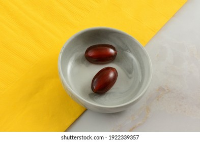 Cola Flavored Fizzy Hard Candy Pieces In Bowl With Yellow Napkin On Table