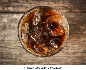 Cola In Glass With Ice From Top View On Table.