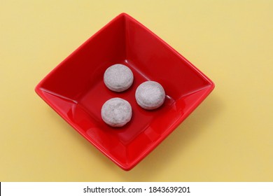 Cola Hard Candy Pieces In Red Candy Dish On Yellow Background