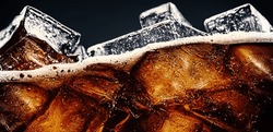 Cola With Ice. Close Up Of The Ice Cubes In Cola Water. Texture Of Carbonate Drink With Bubbles In Glass. Cola Soda And Ice Splashing Fizzing Or Floating Up To Top Of Surface. Cold Drink Background.