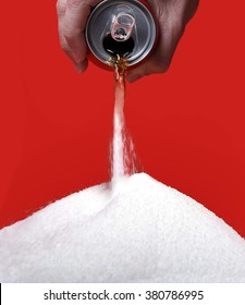 Cola Refreshing Drink Can Pouring The Liquid  Transforming Into Pure White Sugar Representing The Big Amount Of Calories Content In The Soda In Unhealthy Nutrition Concept Isolated On Red Background