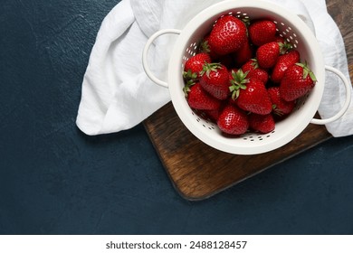 Colander with fresh sweet strawberries on dark background - Powered by Shutterstock