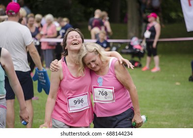 Colchester, Essex, England, UK- 16 July 2017- A Group Of Friend Running To The Finish Line Hand In Hand, At The End Of The Annual Race For Life Event, Helping To Raise Money For Cancer Research UK.