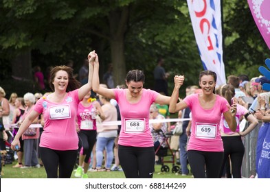 Colchester, Essex, England, UK- 16 July 2017- A Group Of Friend Running To The Finish Line Hand In Hand, At The End Of The Annual Race For Life Event, Helping To Raise Money For Cancer Research UK.