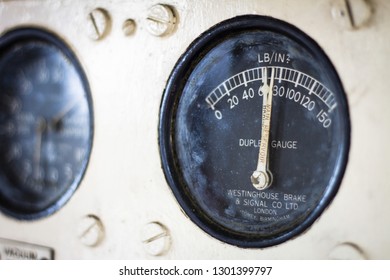 Colchester / Great Britain - May 12, 2013: Vintage Railway Guage In Coltrol Panel.  Black Guage Dial With White Writing On A Cream Panel.