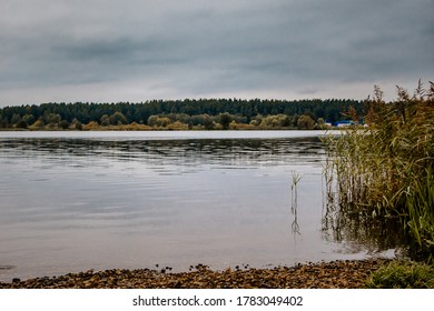Cold autumn lake, cloudy weather. View of the gloomy landscape. - Shutterstock ID 1783049402