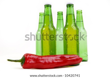 Cold beer bottle over spicy hot chili