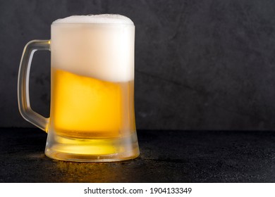 Cold Beer With Foam On Black Backgound