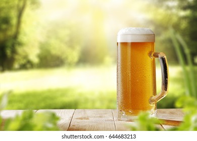 Cold Beer In Garden On Wooden Desk Of Free Space For Your Decoration 