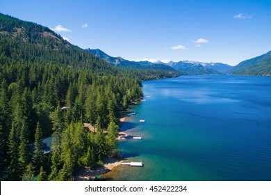 Cold Blue Mountain Lake In State Washington, Lake Cle Elum In The Middle Of The Summer With Waterfront Properties, Mountains And Green Fir Trees. Aerial Photo.