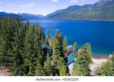 Cold Blue Mountain Lake In State Washington, Lake Cle Elum In The Middle Of The Summer With Waterfront Properties, Mountains And Green Fir Trees. Aerial Photo.