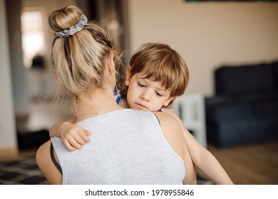 Cold Boy Of 3 Years Old In Arms Of His Mother. Children's Distress At Home.