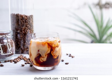 cold brew coffee with milk on white wooden table  - Shutterstock ID 1161211741