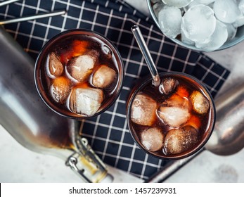 Cold Brew Coffee In A Two Glass With Metal Straw On A Dark Background.Iced Coffee With Ice Cube.Top View.