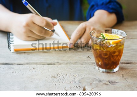 cold brew coffee and working women hand on wooden background