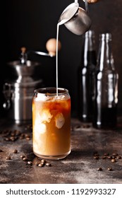 Cold Brew Iced Coffee In A Glass With Milk Or Creamer Pouring Over