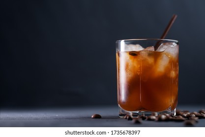 Cold brew iced coffee. Refreshing cold summer drink on a dark table