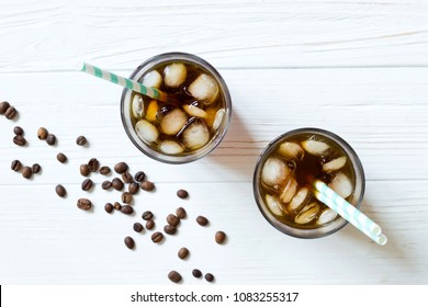 Cold Brew On White Wooden Table. Coffee With Ice On Light Background. Top View