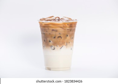 cold brewed iced latte coffee, showing separate in a layer the bottom as milk top by coffee shot in a plastic glass 16oz. isolated white background - Shutterstock ID 1823834426