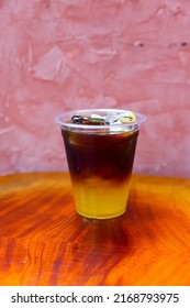 Cold Brewed Iced Latte Coffee, Showing Separate In A Layer The Bottom As Milk Top By Coffee Shot In A Plastic Glass