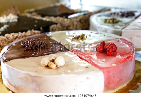 Cold cakes,\
various flavors. Multi-colored cake divided into portions  :\
Chocolate, strawberry, hazelnut and\
pistachio
