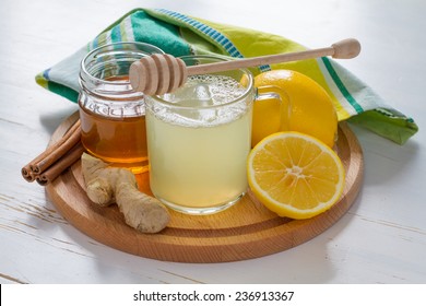 Cold Care - Tea, Honey, Lemon, Ginger, Cinnamon Sticks On White Wood Background