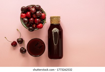 Cold Cherry Juice In A Glass And Bottle With Ripe Berries. Top View, Copy Space For Text. The Concept Of Summer Refreshing Drink Morse Or Kompot.