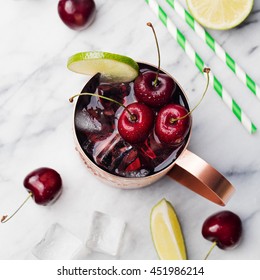 Cold Cherry Moscow Mules Cocktail With Ginger Beer, Vodka, Lime Marble Background Copy Space Top View