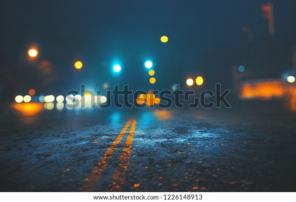 A\
cold city street on a rain night with lights and\
bokeh