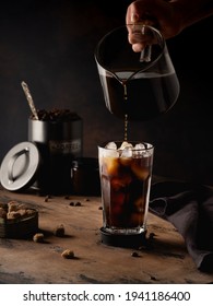 Cold coffee with cream on a dark background