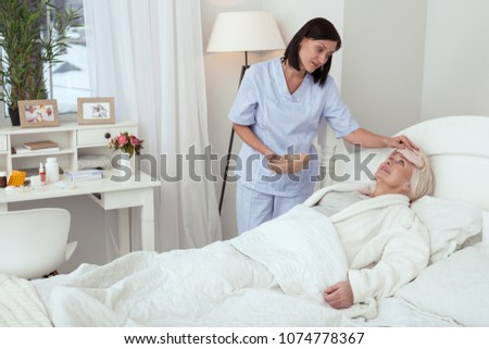 Similar – Caregiver auscultating senior woman