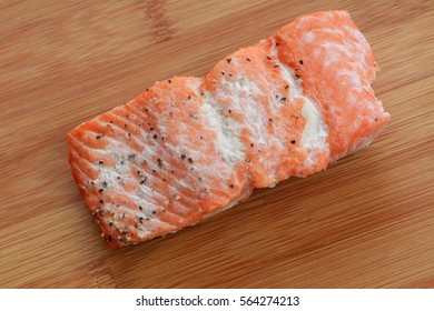 Cold Cooked Sockeye Salmon Filet On Bamboo Cutting Board In Horizontal Format And Shot In Natural Light
