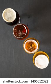 Cold Craft Beer Assortment On A Black Background, Top View. Overhead, From Above. 