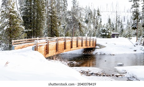 Cold creek flows under a foot bridge in Idaho