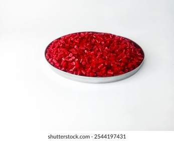cold cutting type masterbatch granules red color in pantri cup, pigment coloring resin raw material plastic, isolated on white background for product catalog design profile of industrial plastic