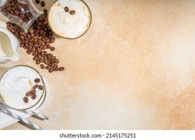 Cold dairy coffee drink with milk, whipped cream. Foamy frappe, latte, cappuccino, on a cream background, space for text. Summer cold coffee cocktail