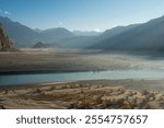 
The Cold Desert of Skardu is a stunning, otherworldly landscape, characterized by vast stretches of barren, golden sand dunes surrounded by snow-capped mountains, serene desert, located in Pakistan.