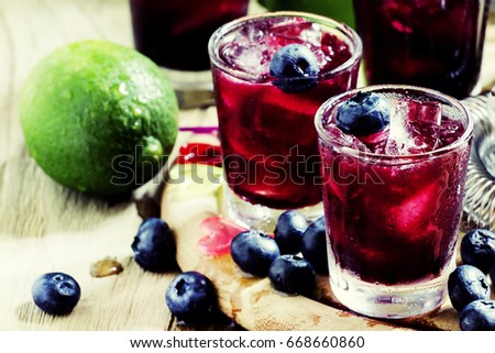 Cold drink with blueberry, lim and ice, selective focus