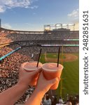 Cold drinks with friends at a baseball game at Coors Field in Denver, Colorado
