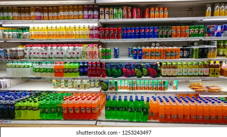 Cold Drinks, Juices, Water, Soda Etc From Popular FMCG Brands Displayed On Aisle In A Modern Grocery Outlet At A Mall, Delhi, India, Circa 2019