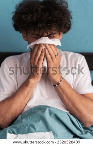 Cold and flu concept. Sick man suffering from running stuffy nose. Upset ill guy blowing her nose using paper napkin tissue. Close-up