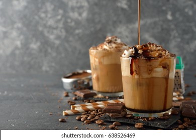 Cold frappe coffee with cream on a gray background