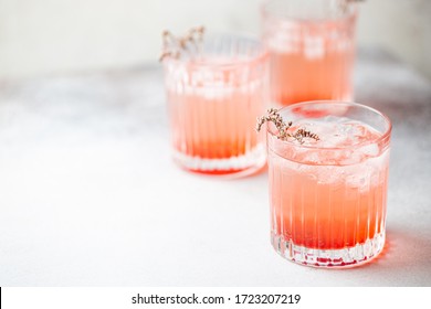 Cold Fresh Pink Lemonade Drink With Ice In A Glass On White Background, Selective Focus