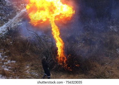 Cold Frosty Evening On The River Bank. Lost Hikers Kindles A Rescue Fire Using Gasoline. Campfire. Kindle Fire. Rescue Fire. 