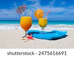 Cold fruit drinks on the beach on the sand on a hot summer day