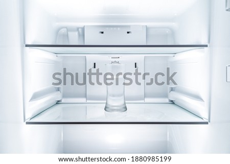 Cold glass of water in clean refridgerator