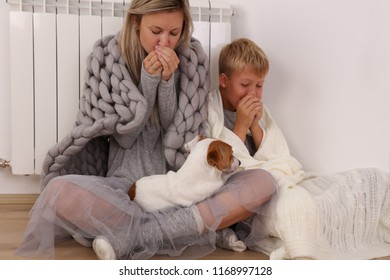 Cold Home, Freezing Family, Mother And Son, Wrapped In Blanket Sitting Near Heater