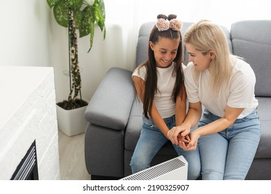 Cold Home, Freezing Family, Mother And Daughter Sitting Near Heater