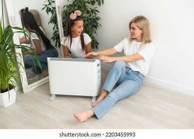 Cold Home, Freezing Family, Mother And Daughter Sitting Near Heater