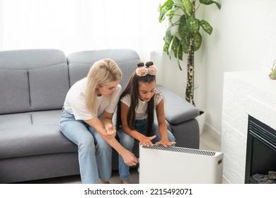 Cold Home, Freezing Family, Mother And Daughter Sitting Near Heater